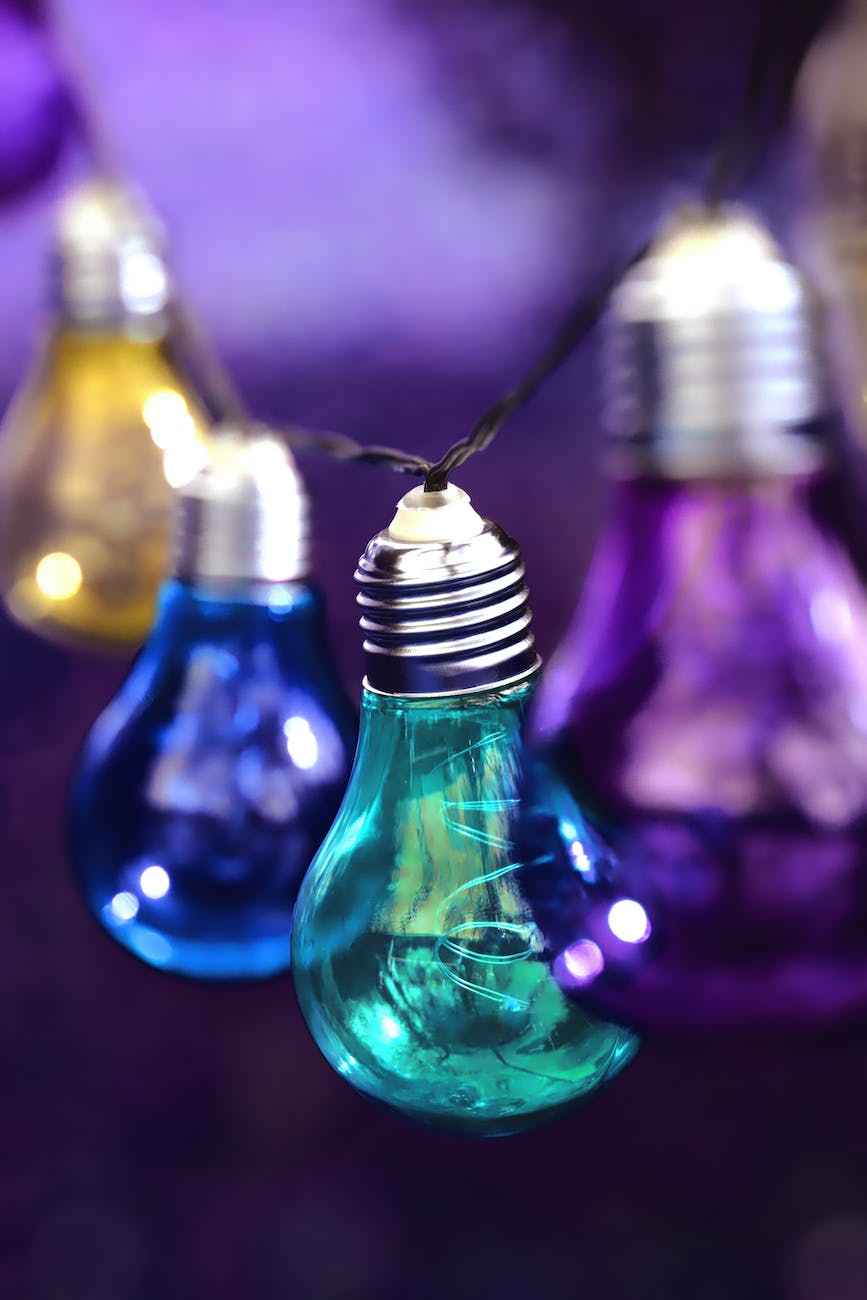 purple teal blue and yellow hanging light bulbs