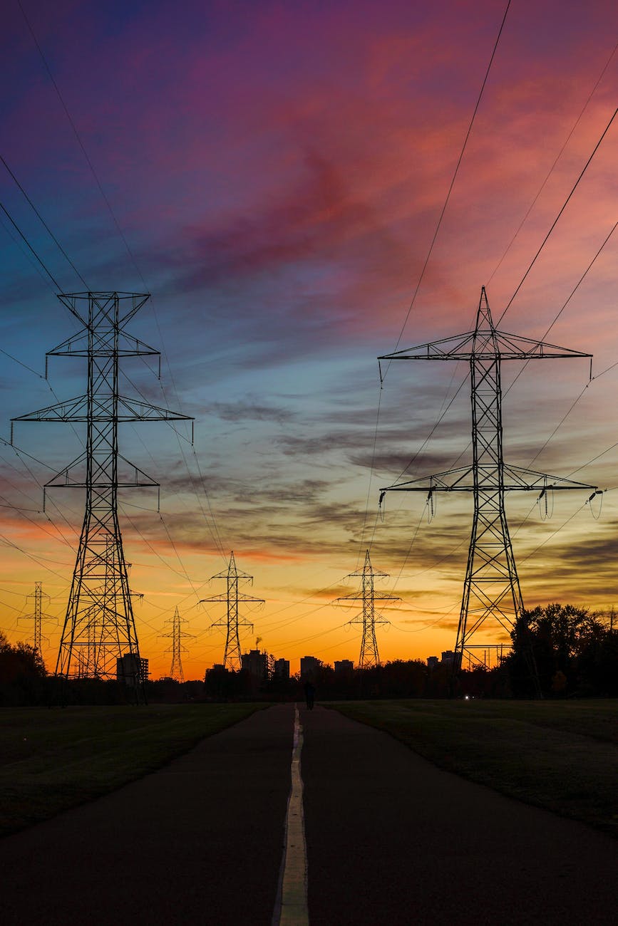 silhouette photo of transmission lines during golden hour